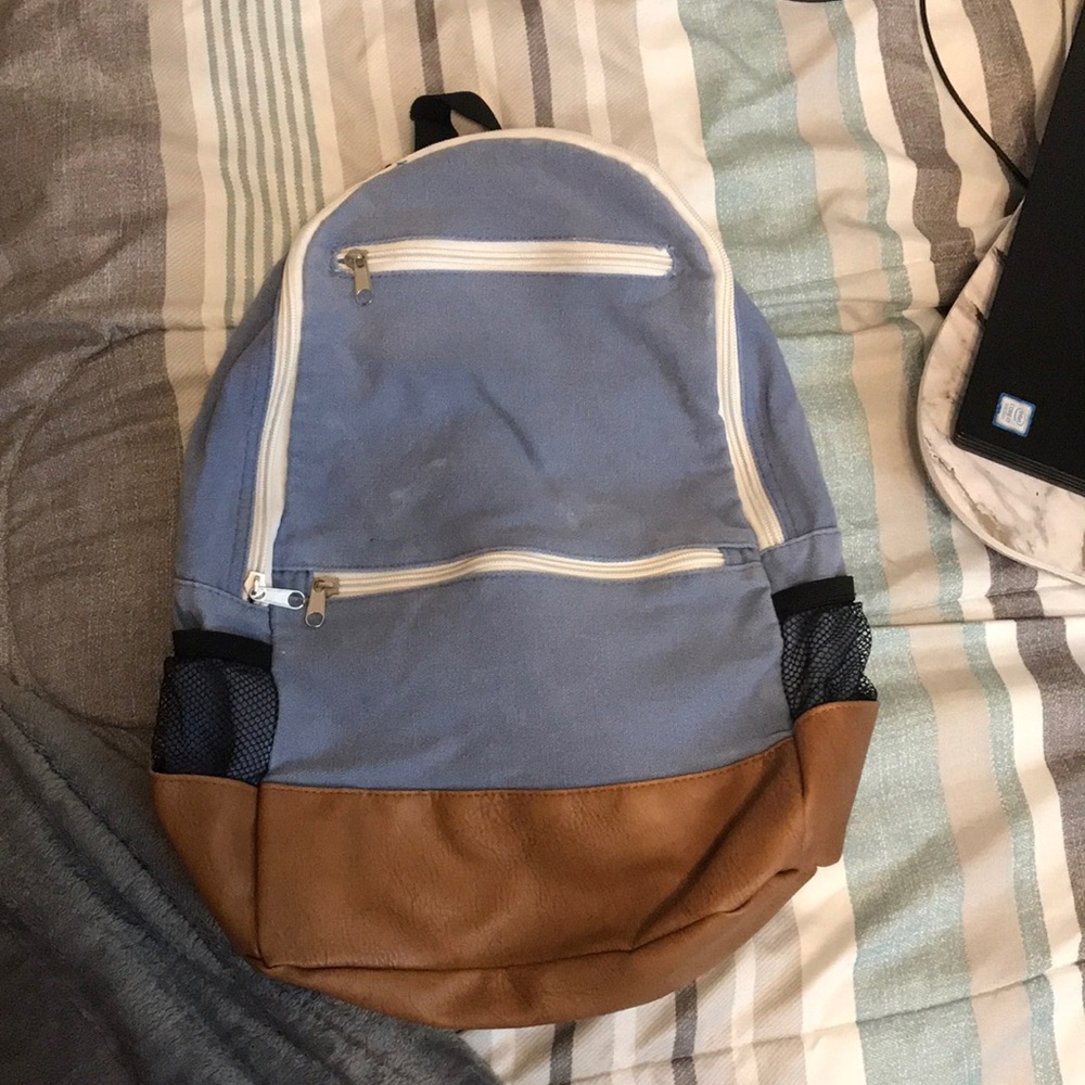 Distressed denim and leather backpack